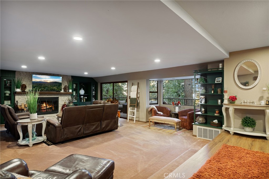 31353 Lightfoot Way Running Springs, CA 92382 - Photo 2 of 42 a living room with furniture a fireplace and a large window