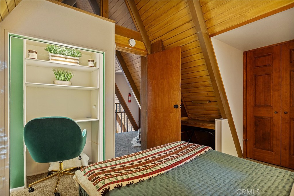 31353 Lightfoot Way Running Springs, CA 92382 - Photo 21 of 42 a bedroom with a bed and a chair