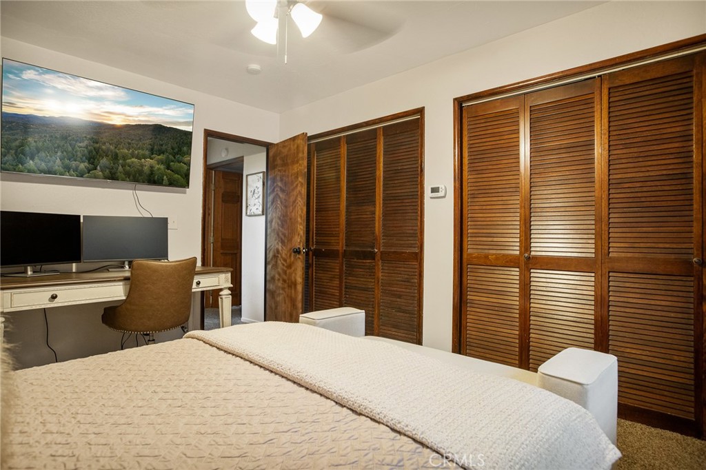 31353 Lightfoot Way Running Springs, CA 92382 - Photo 24 of 42 a bedroom with a large bed and a flat tv screen