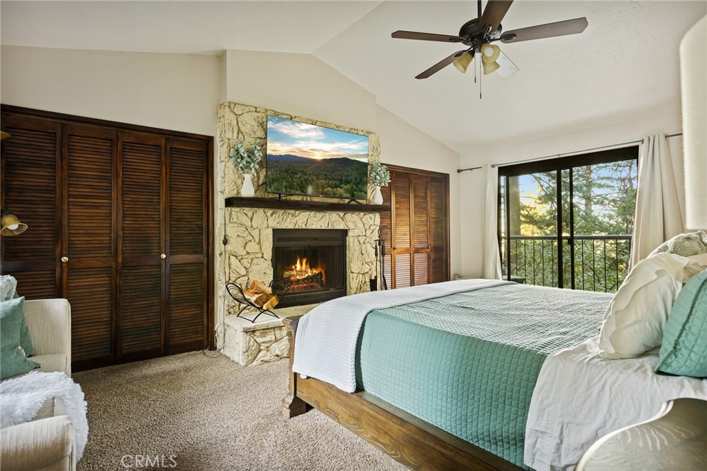 31353 Lightfoot Way Running Springs, CA 92382 - Photo 30 of 42 a bedroom with a bed and a fireplace