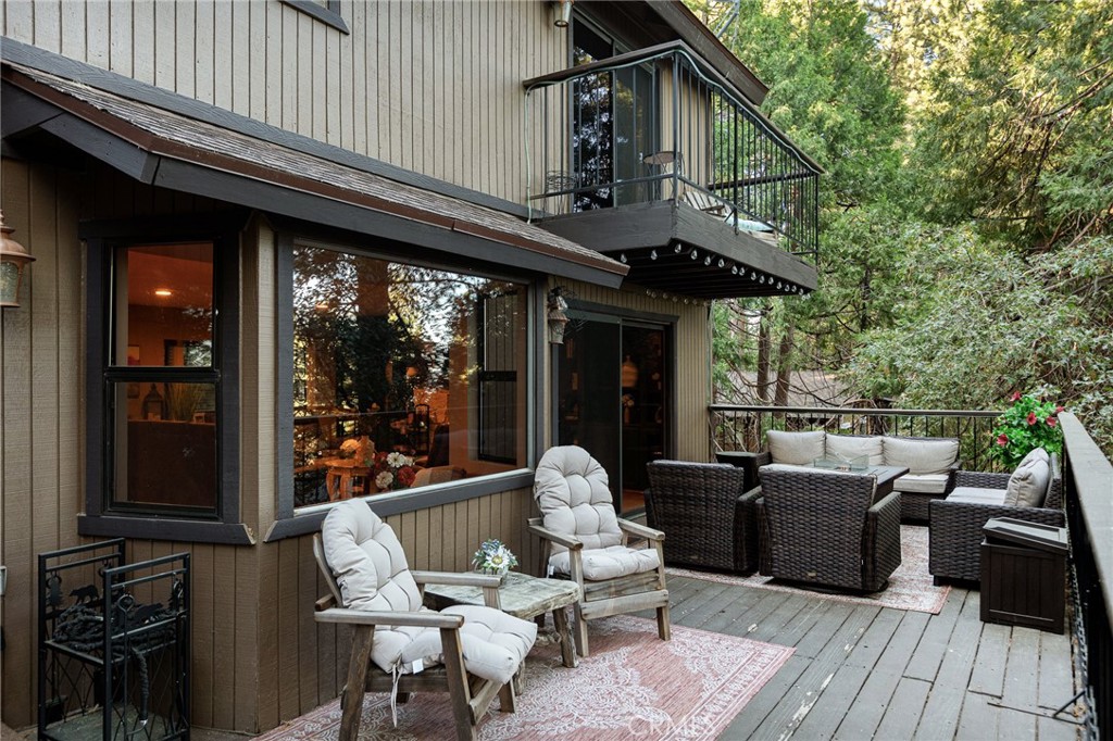 31353 Lightfoot Way Running Springs, CA 92382 - Photo 35 of 42 a patio with wooden table and chairs