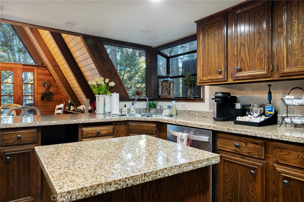 31353 Lightfoot Way Running Springs, CA 92382 - Photo 9 of 42 a kitchen with granite countertop wooden cabinets and a sink