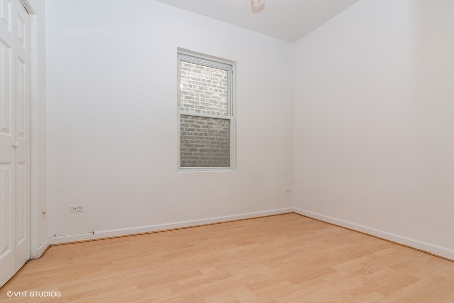 912 North Ashland Avenue, Unit 3C Chicago, IL 60622 - Photo 6 of 7 an empty room with a window
