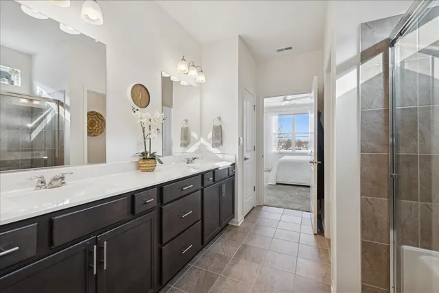 a spacious bathroom with a double vanity sink mirror and double