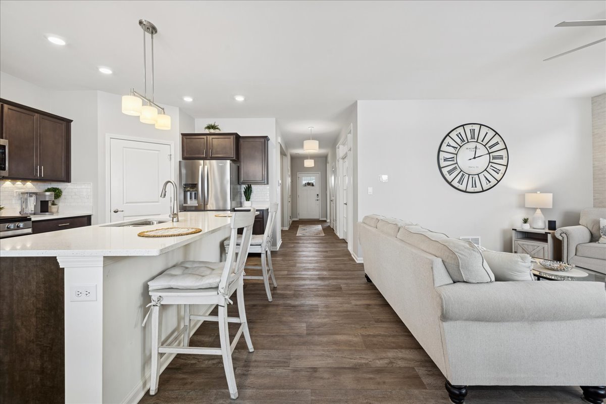 1639 Rochester Road Pingree Grove, IL 60140 - Photo 6 of 21 a living room with furniture a flat screen tv and kitchen view