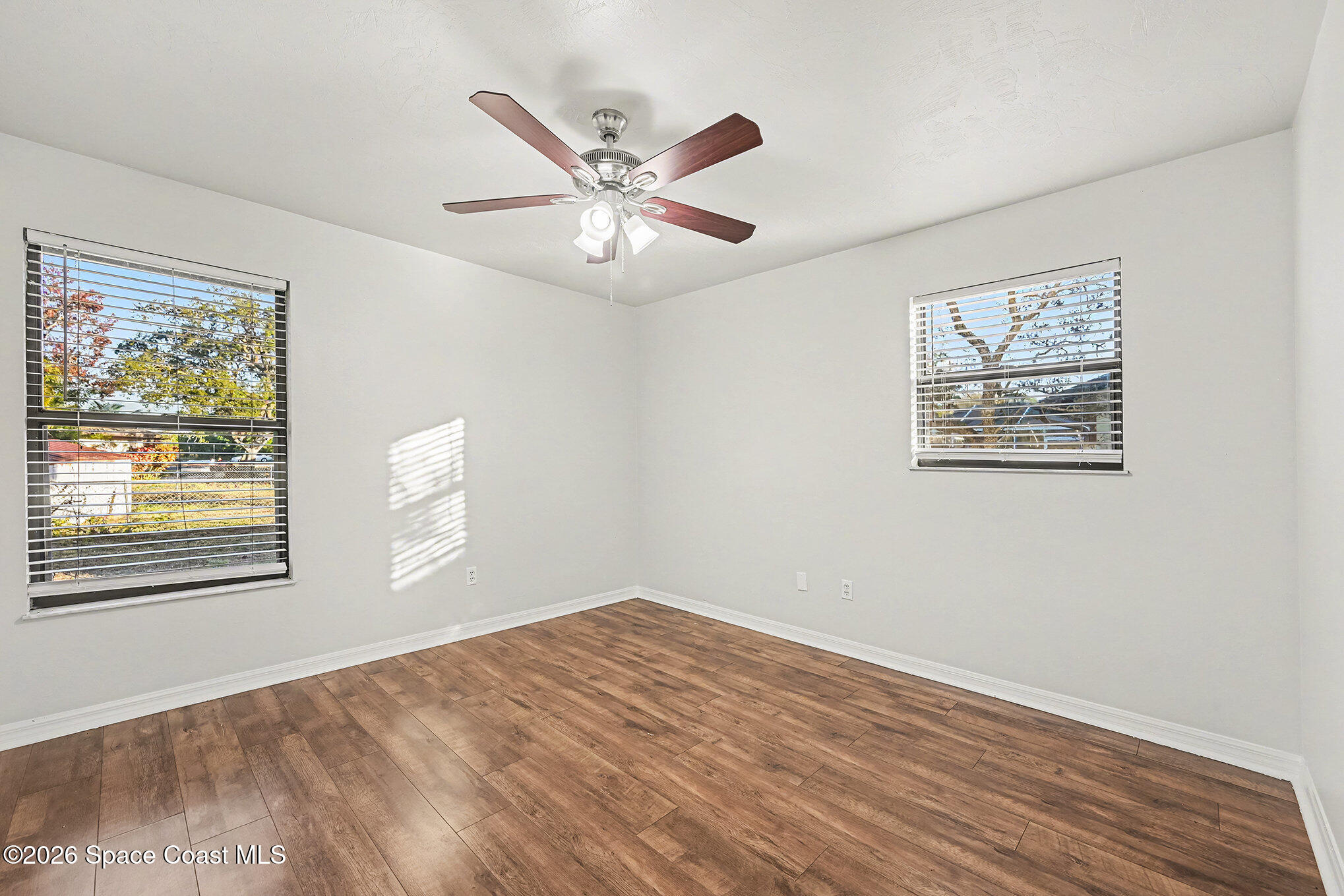 110 Cardinal Drive Sebastian, FL 32958 - Photo 12 of 23 a view of an empty room with wooden floor and a window