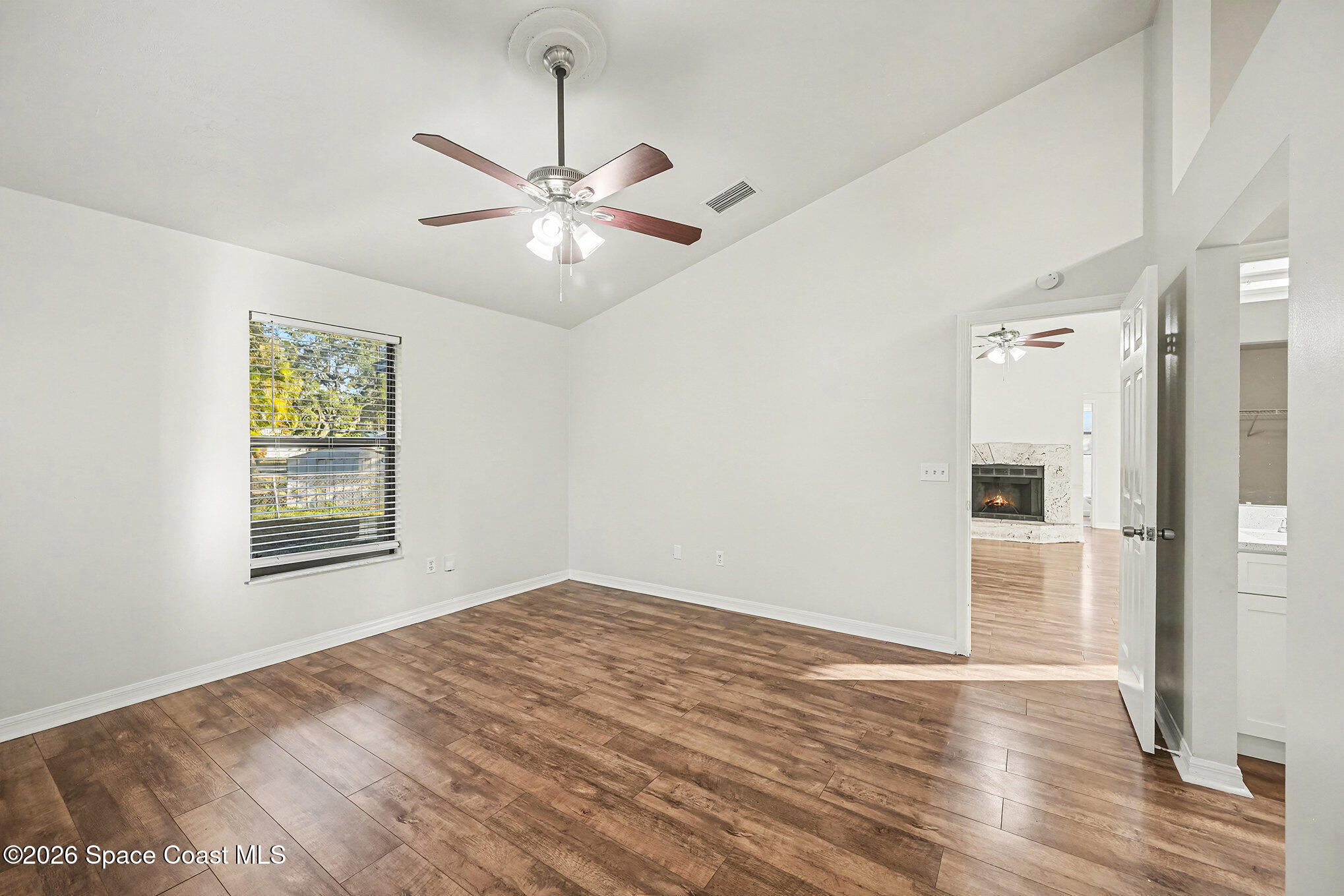 110 Cardinal Drive Sebastian, FL 32958 - Photo 13 of 23 a view of empty room with wooden floor and fan