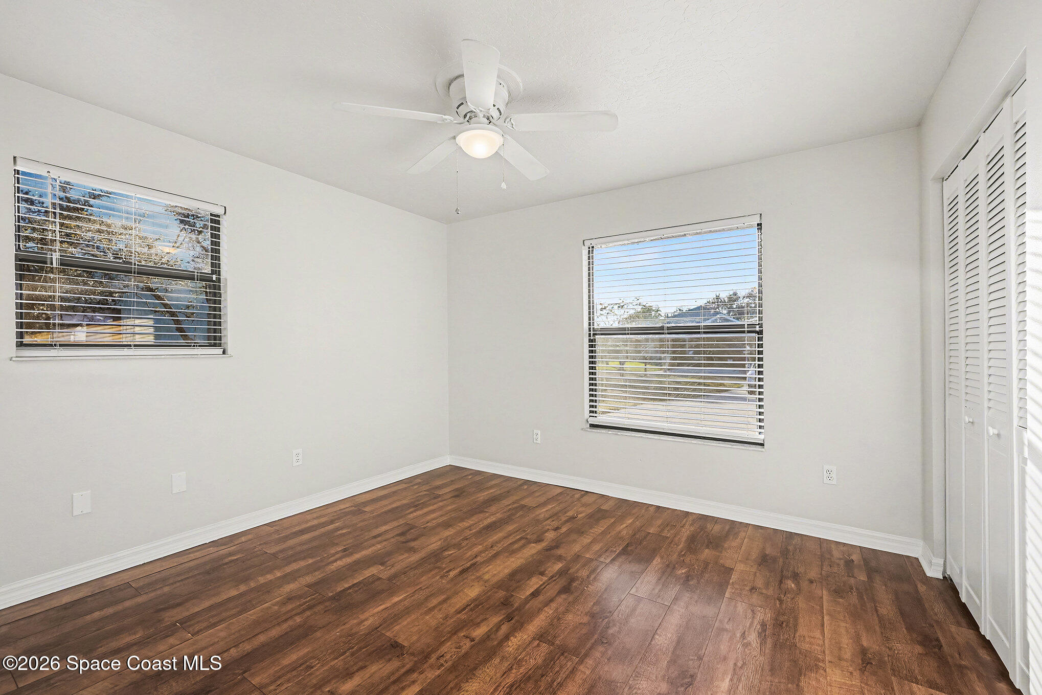 110 Cardinal Drive Sebastian, FL 32958 - Photo 17 of 23 a view of an empty room with wooden floor and a window