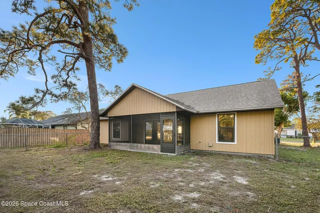 a view of a house with a tree in the background
