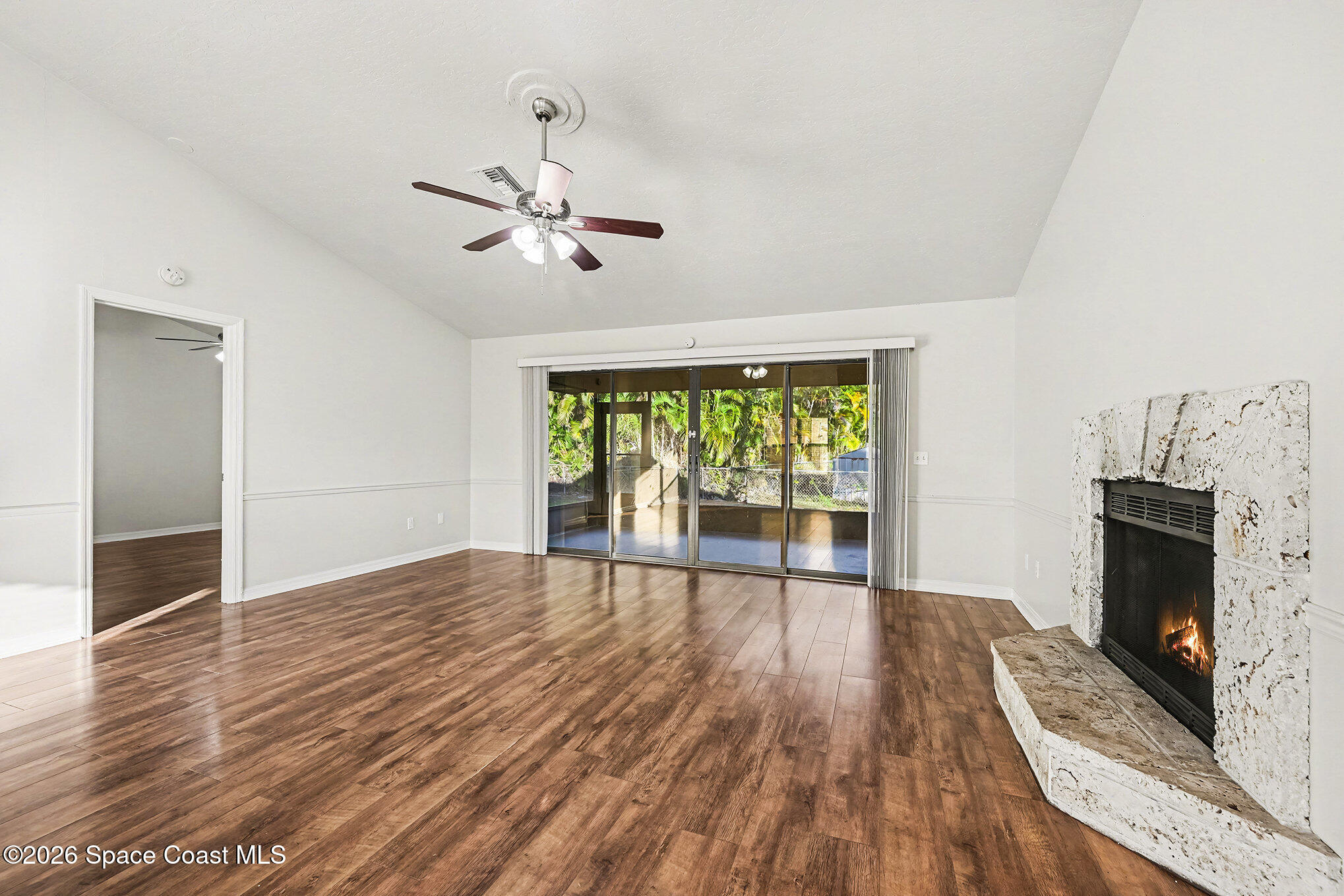 110 Cardinal Drive Sebastian, FL 32958 - Photo 5 of 23 a view of empty room with wooden floor and fan
