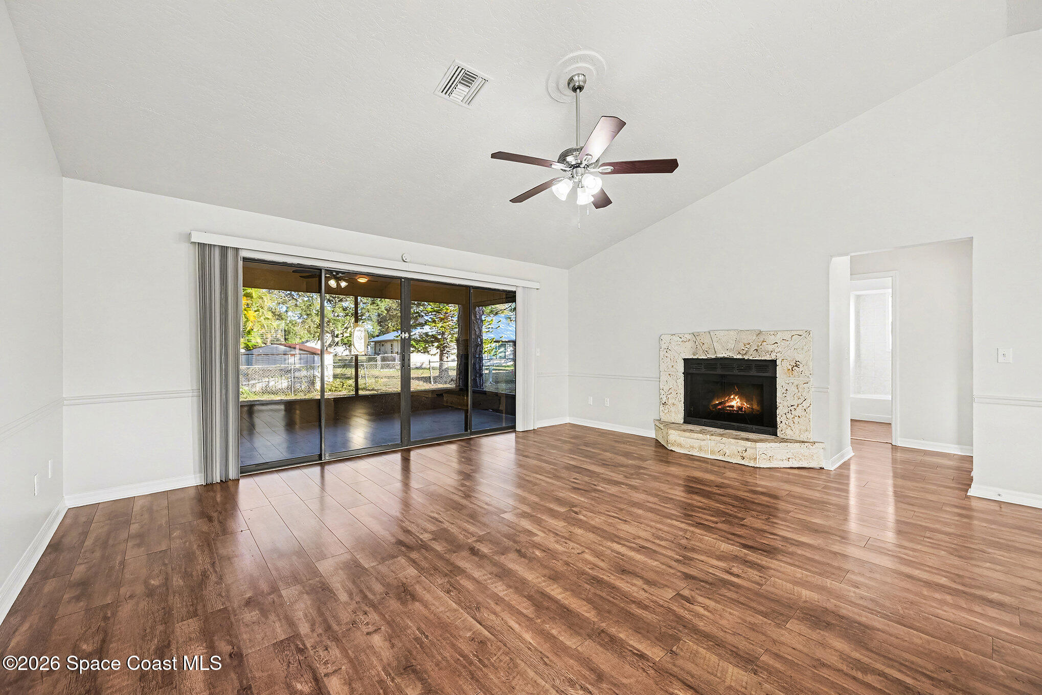 110 Cardinal Drive Sebastian, FL 32958 - Photo 7 of 23 a view of an empty room with wooden floor and a window