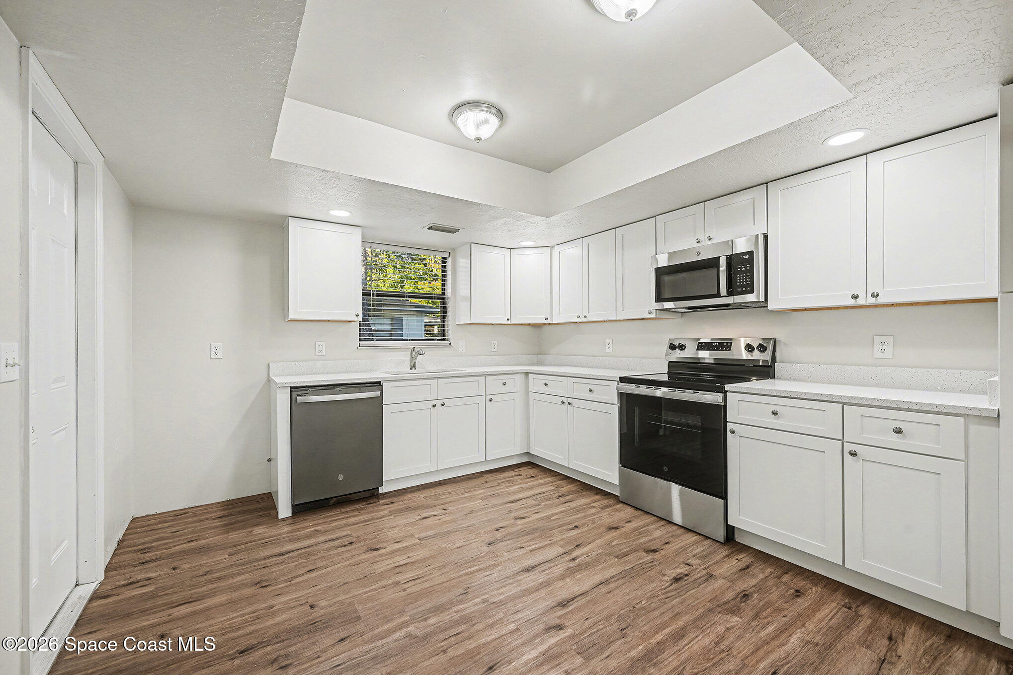 110 Cardinal Drive Sebastian, FL 32958 - Photo 8 of 23 a kitchen with granite countertop a stove top oven sink and cabinets