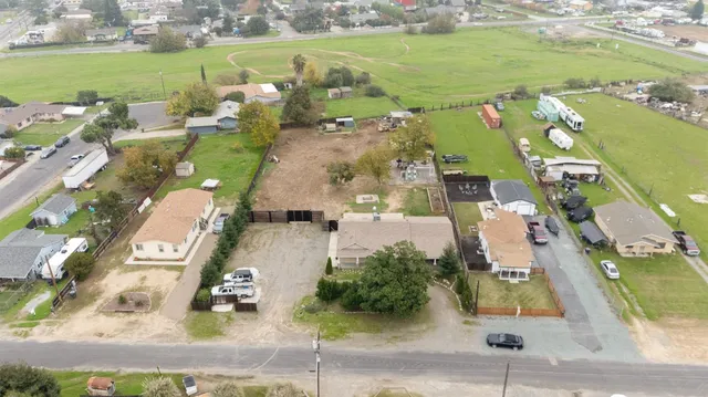 an aerial view of a city with lots of residential buildings and lake view