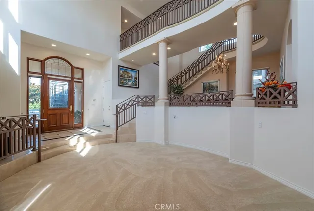 a view of entryway livingroom and hall with wooden floor