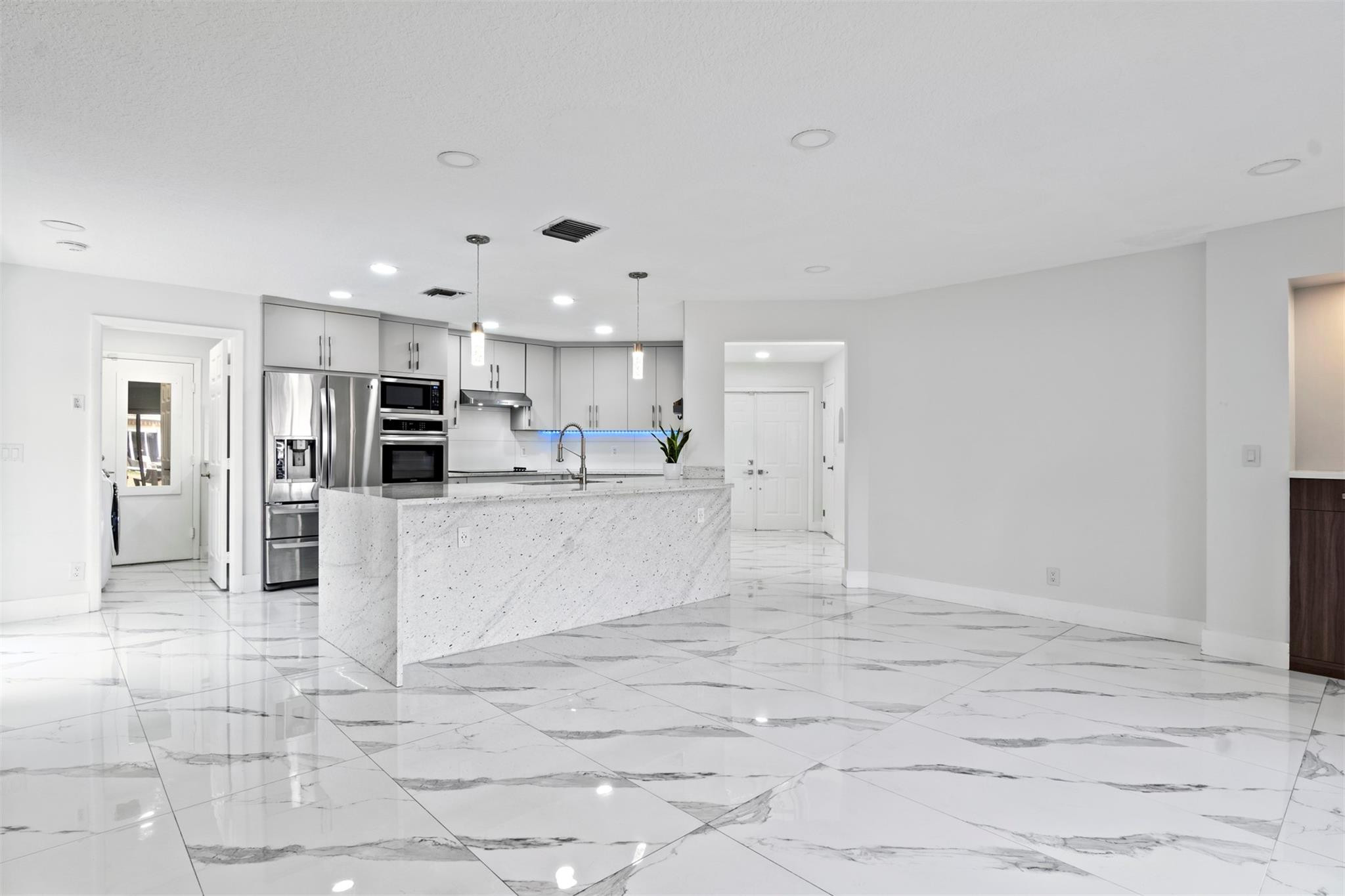 6357 Brava Way Boca Raton, FL 33433 - Photo 43 of 73 a view of kitchen with stainless steel appliances kitchen island granite countertop a refrigerator and cabinets