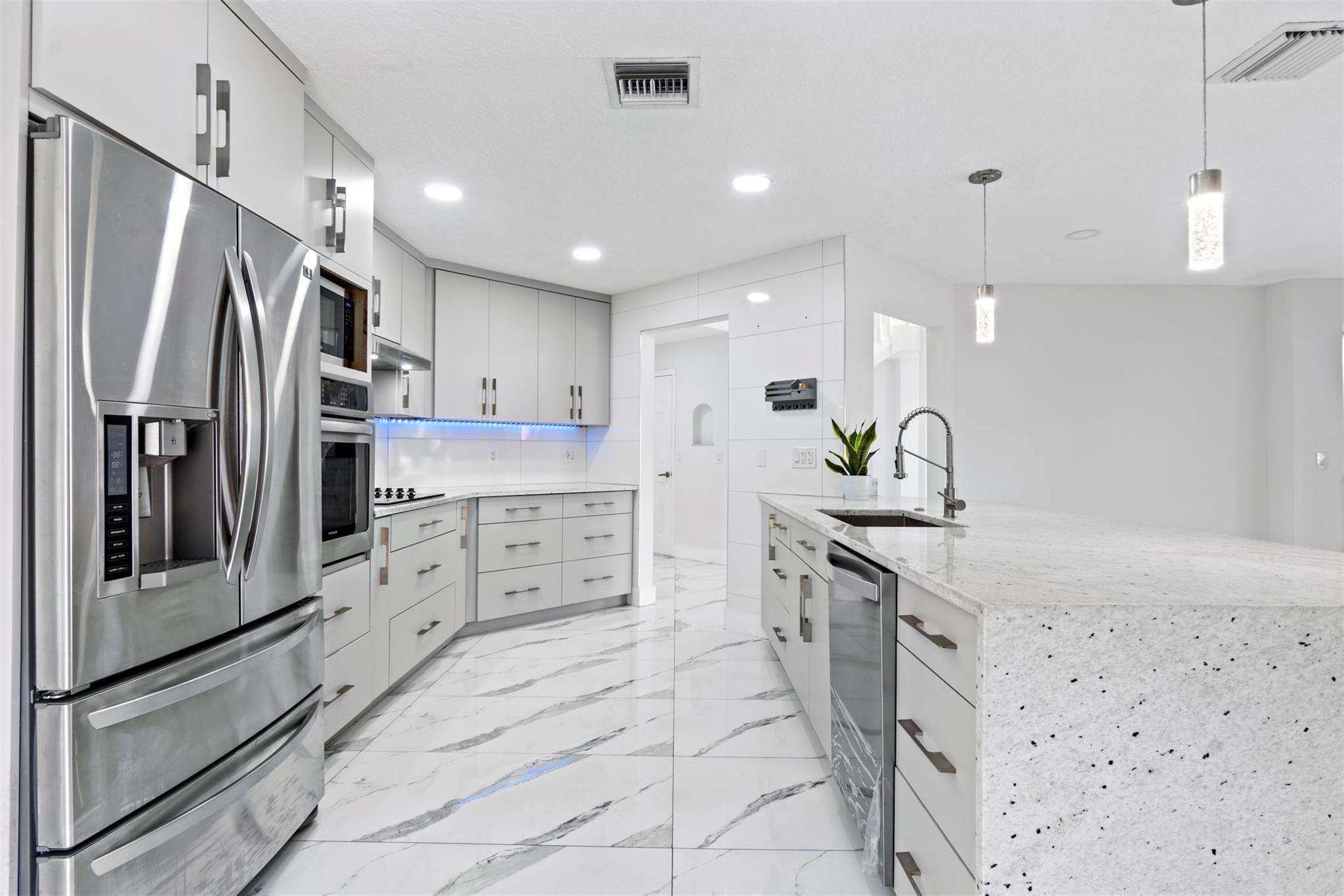 6357 Brava Way Boca Raton, FL 33433 - Photo 46 of 73 a kitchen with stainless steel appliances granite countertop a refrigerator and a sink
