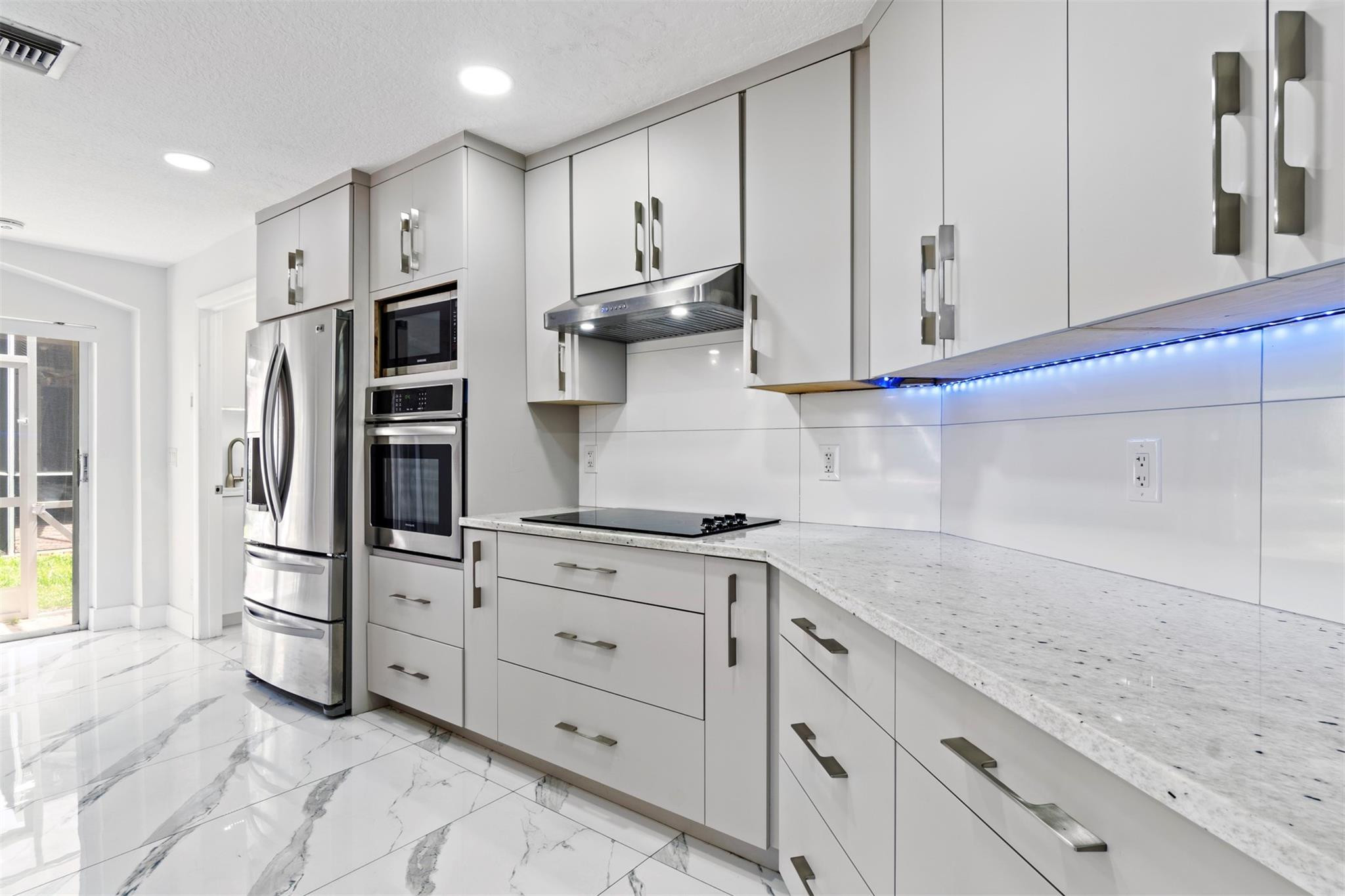 6357 Brava Way Boca Raton, FL 33433 - Photo 48 of 73 a kitchen with stainless steel appliances granite countertop a refrigerator and a stove