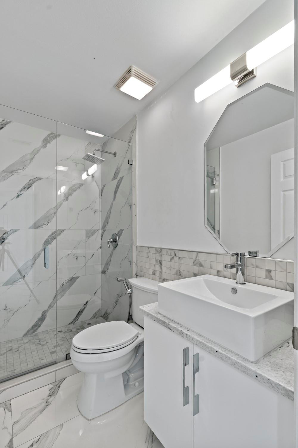 6357 Brava Way Boca Raton, FL 33433 - Photo 57 of 73 a bathroom with a sink a toilet and shower