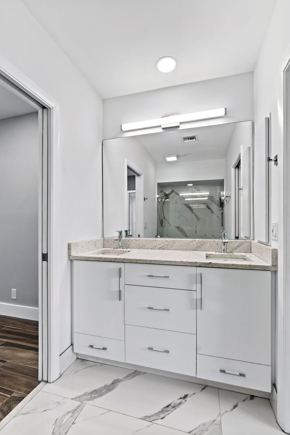 6357 Brava Way Boca Raton, FL 33433 - Photo 64 of 73 a bathroom with a granite countertop sink mirror and cabinets
