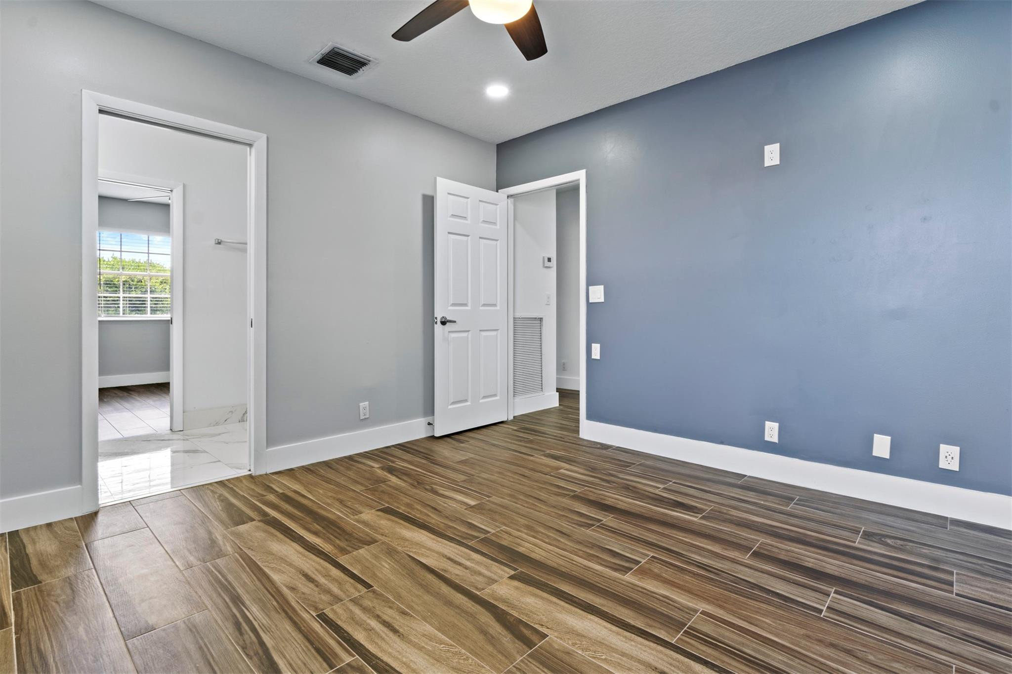 6357 Brava Way Boca Raton, FL 33433 - Photo 67 of 73 a view of an empty room and window and wooden floor