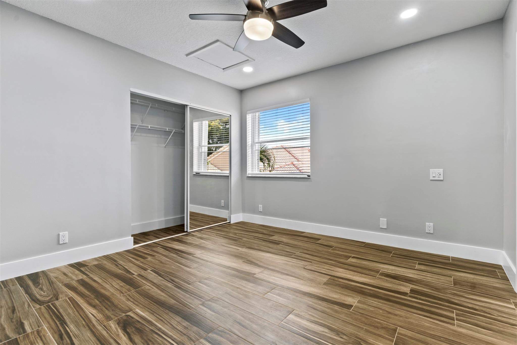 6357 Brava Way Boca Raton, FL 33433 - Photo 68 of 73 wooden floor in an empty room with a window
