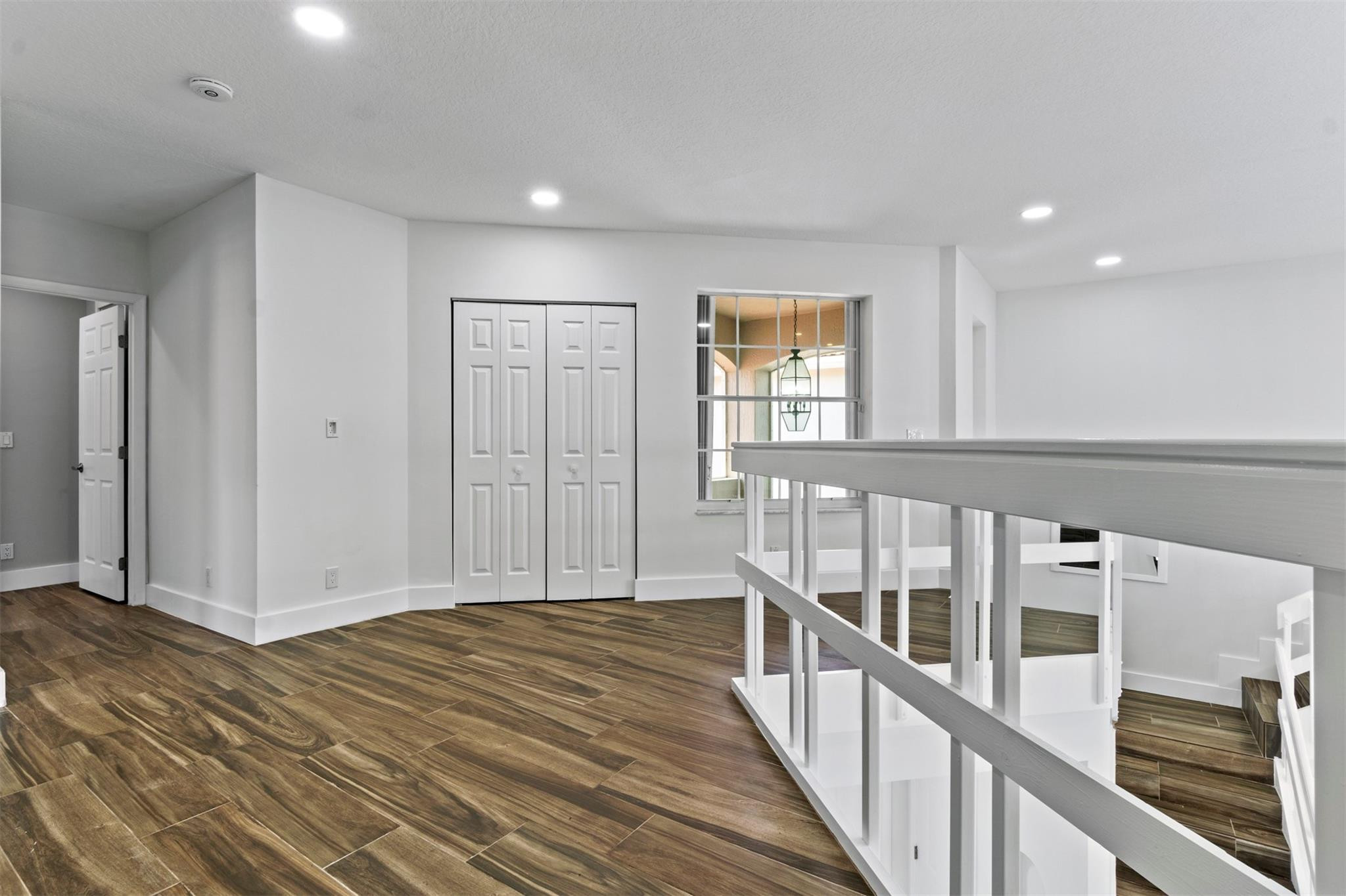 6357 Brava Way Boca Raton, FL 33433 - Photo 71 of 73 a view of a hallway with wooden floor and staircase