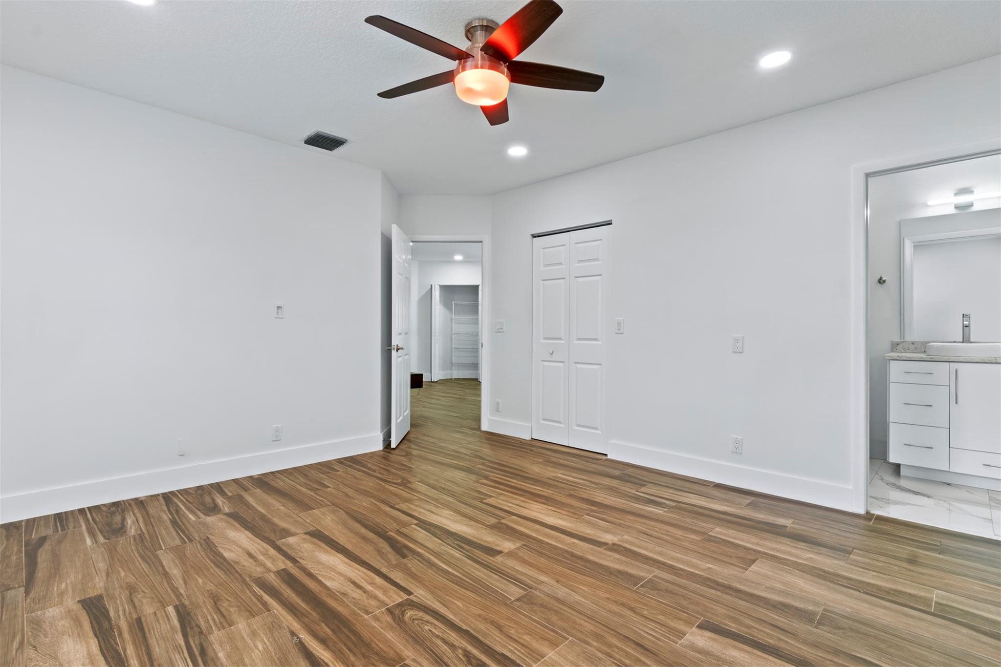 6357 Brava Way Boca Raton, FL 33433 - Photo 73 of 73 a view of a room with wooden floor and a ceiling fan