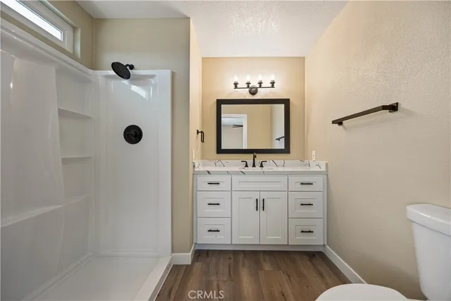 a bathroom with a sink a mirror and a toilet