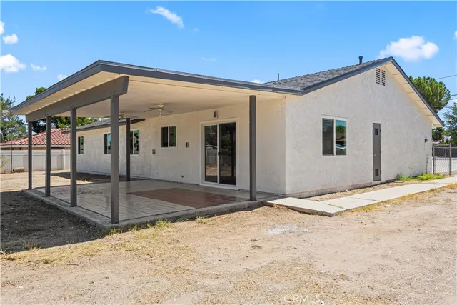 a view of a house with wooden fence