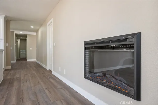 a room with wooden floor and a fireplace