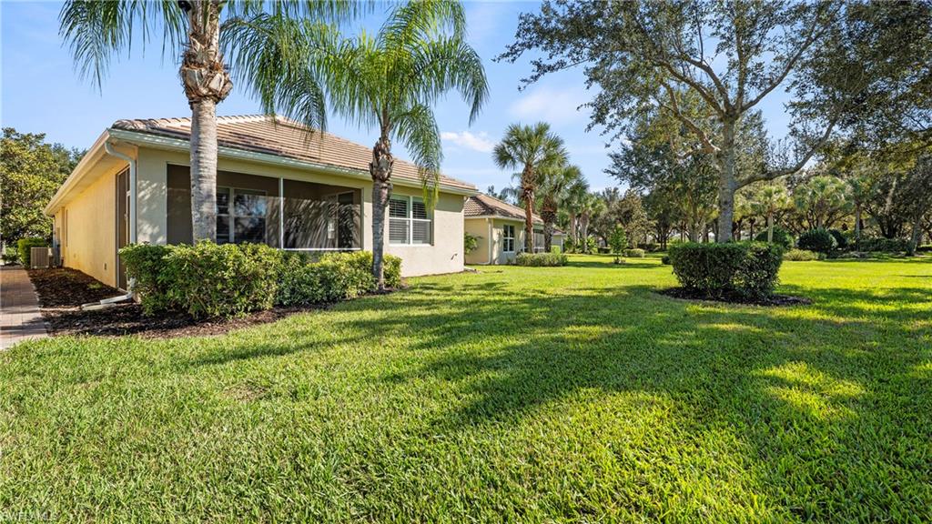 5113 Da Vinci Way Ave Maria, FL 34142 - Photo 19 of 31 a front view of house with yard and green space