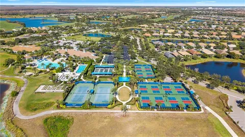 an aerial view of residential houses with outdoor space and swimming pool