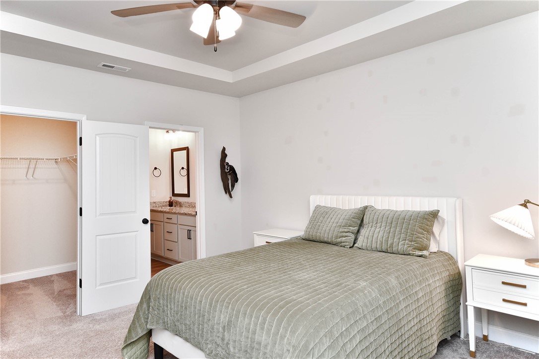 3131 Lullwater Drive Anderson, SC 29624 - Photo 16 of 31 This primary bedroom suite offers a tranquil retreat with a luxurious en-suite bathroom and a spacious walk-in closet.