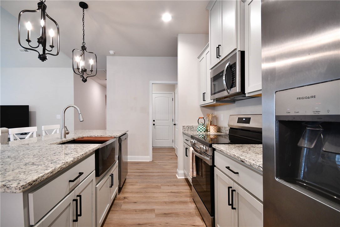3131 Lullwater Drive Anderson, SC 29624 - Photo 8 of 31 This bright kitchen features ample counter space and modern appliances, perfect for any culinary enthusiast. The island is also great for entertaining.