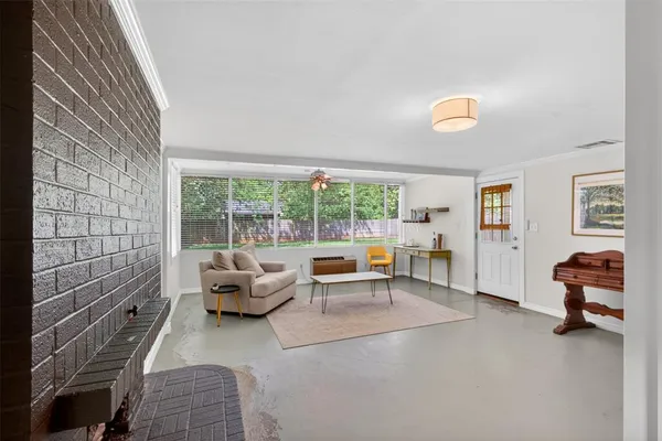 a living room with furniture and floor to ceiling windows