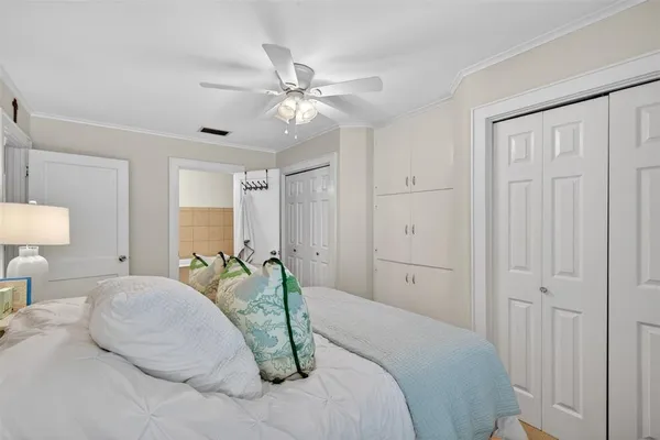 a bedroom with a large bed and a chandelier