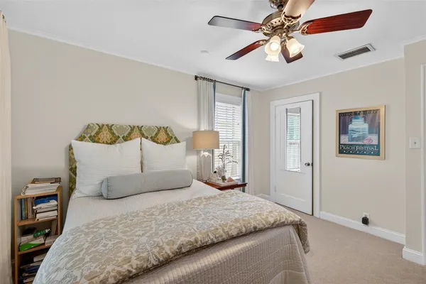 a bedroom with a bed and a ceiling fan
