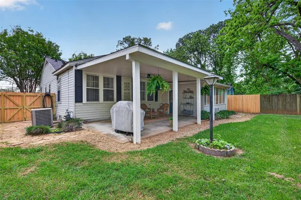 a front view of house with a garden and yard