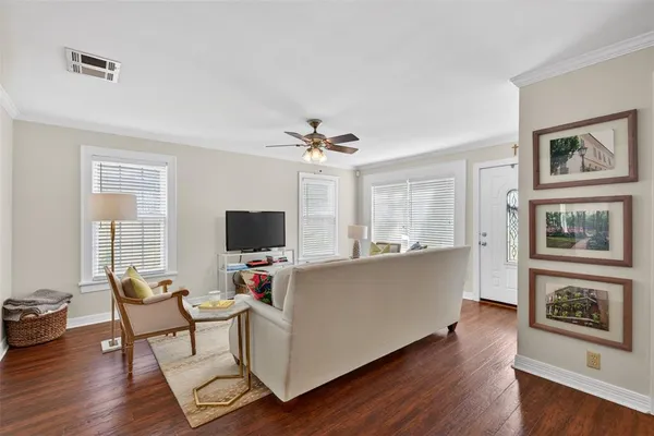 a living room with furniture a flat screen tv and a large window