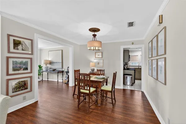 a view of a dining room with furniture wooden floor and a window