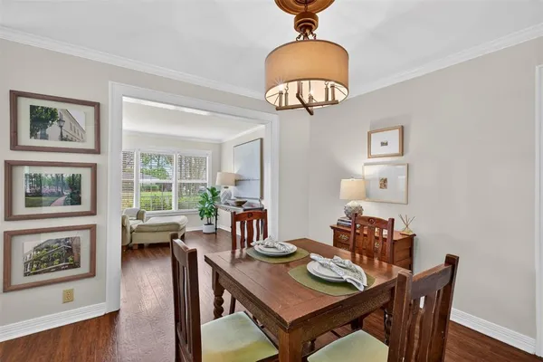 a view of a dining room with furniture wooden floor and chandelier