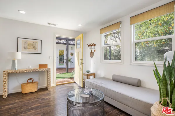 a living room with furniture and a potted plant