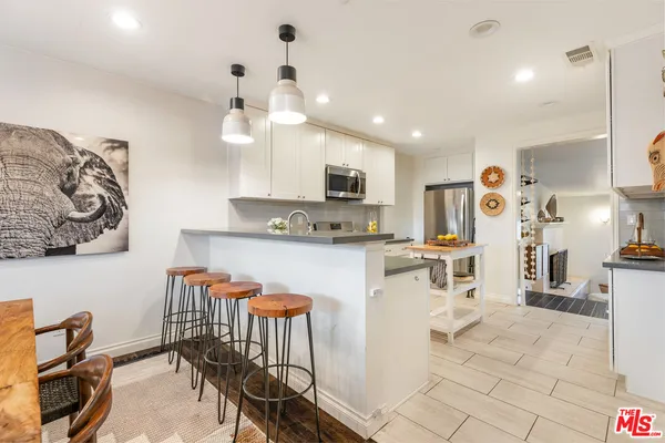 a kitchen with stainless steel appliances kitchen island granite countertop a sink and cabinets