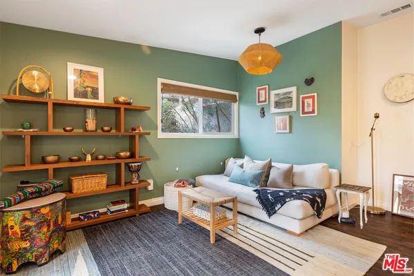 a bedroom with furniture and a window