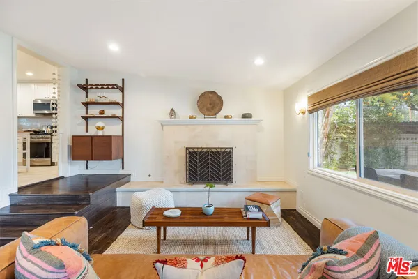 a living room with furniture a rug and a large window