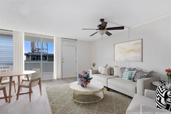 a living room with furniture and a view of kitchen