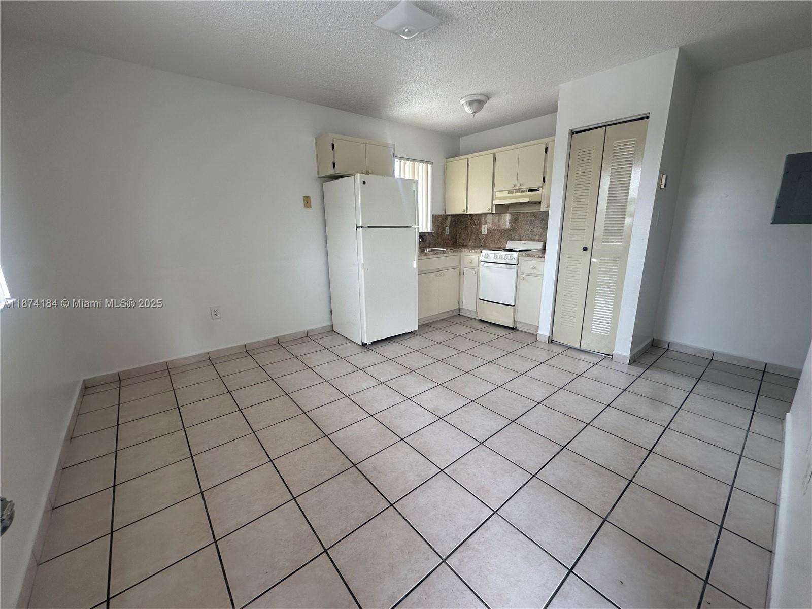 290 East 7th Street, Unit 201 Hialeah, FL 33010 - Photo 1 of 4 a kitchen with a sink refrigerator and cabinets