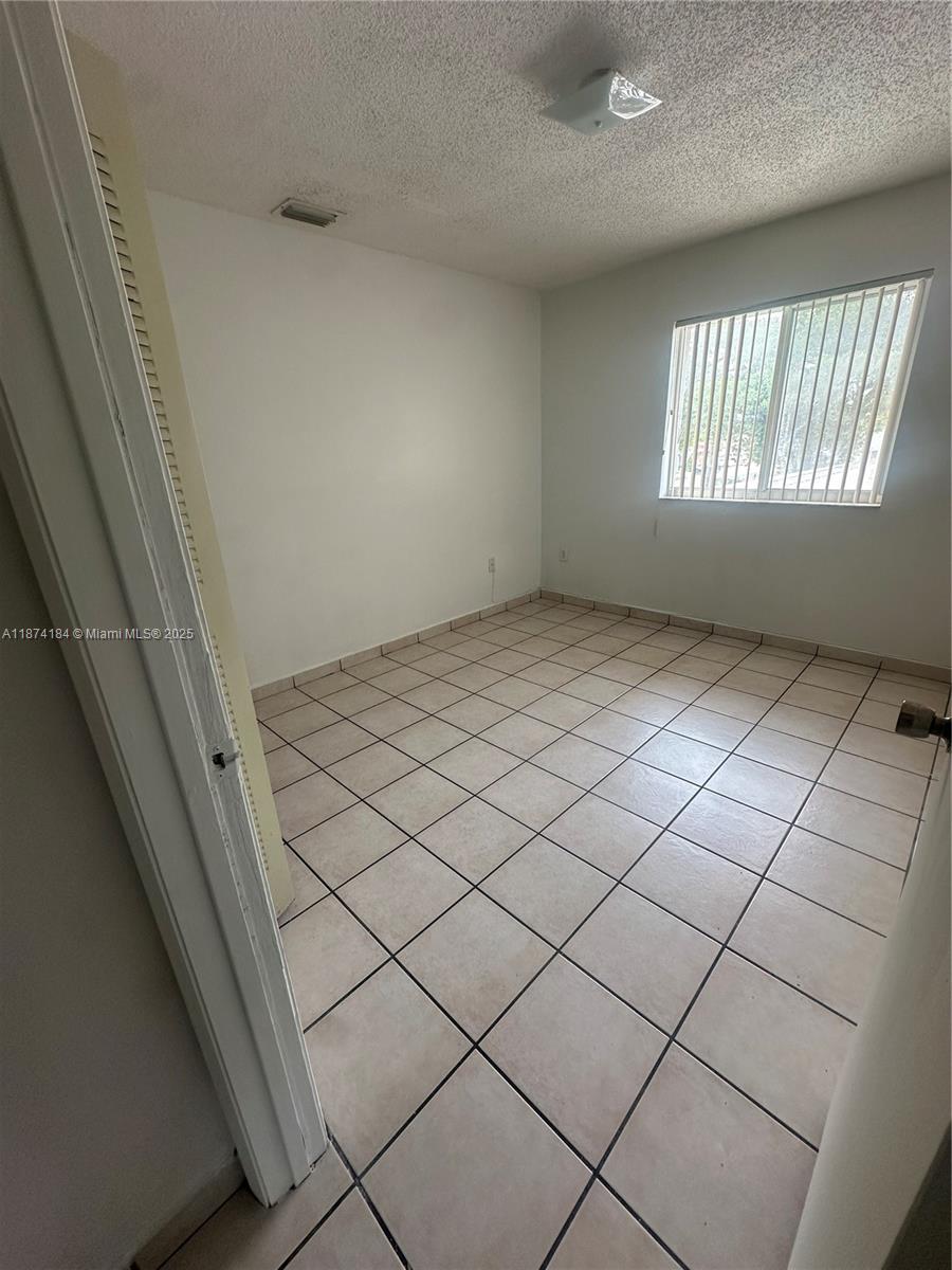 290 East 7th Street, Unit 201 Hialeah, FL 33010 - Photo 2 of 4 a view of an empty room and window