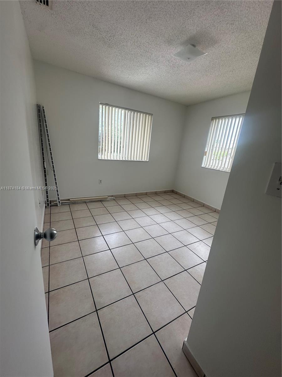 290 East 7th Street, Unit 201 Hialeah, FL 33010 - Photo 3 of 4 a view of an empty room and window