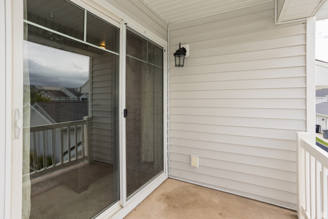 2452 West 500 South, Unit 2 Springville, UT 84663 - Photo 22 of 23 Upper-level balcony featuring a sliding glass door, white railing, and exterior wall lantern
